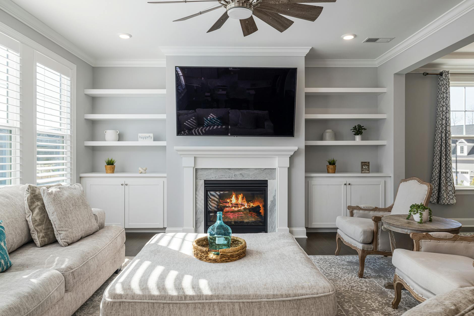 Stylishly decorated living room featuring a modern fireplace and cozy furnishings.