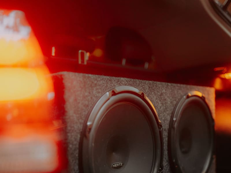 Custom dual subwoofer enclosure installed in a vehicle trunk