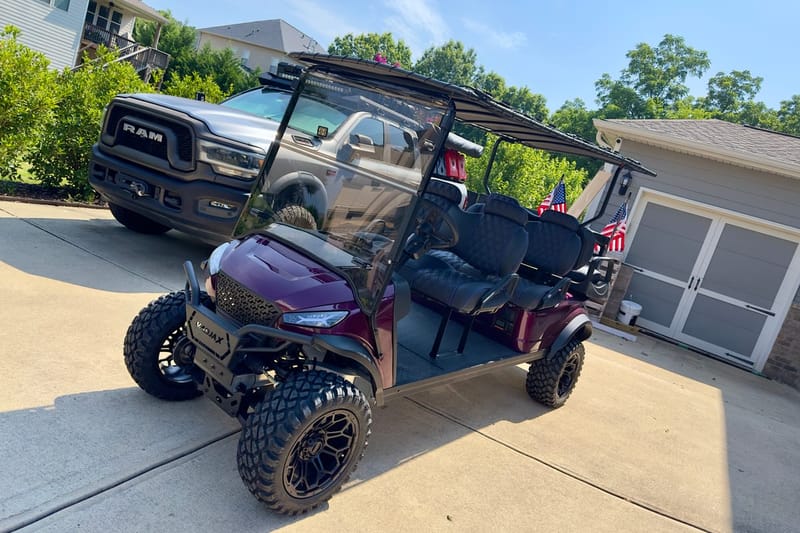 Customized lifted golf cart with aftermarket wheels