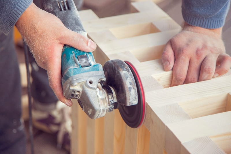 Handyman mounting a shelf on an interior wall